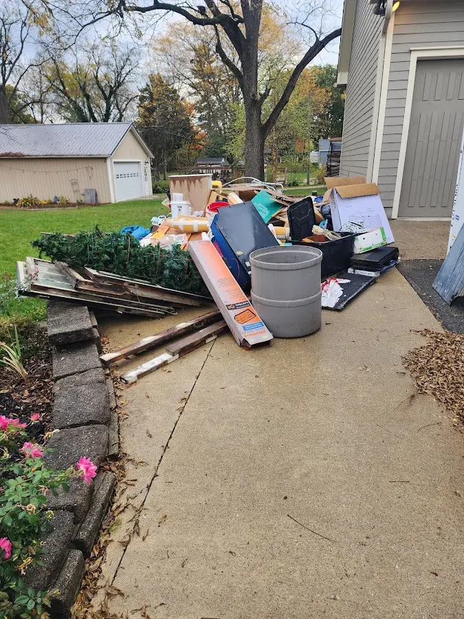 Dumpster being loaded with debris for Residential Dumpster Rental in Webster Groves